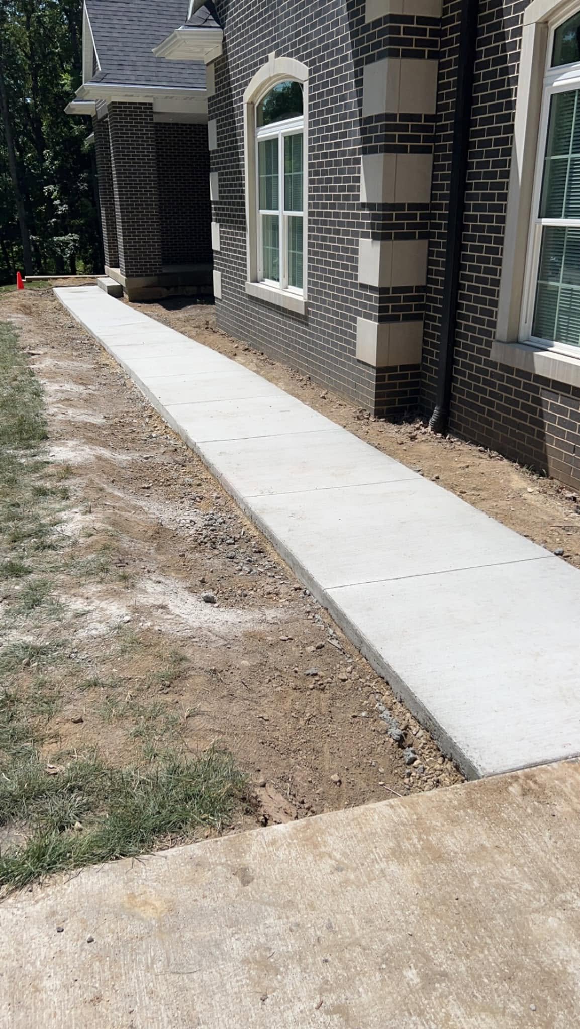 Concrete sidewalk at upscale home